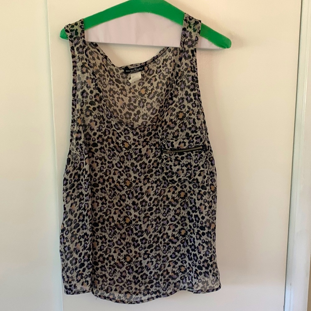 Sleeveless tank top with zippered pocket on front. Runs big.